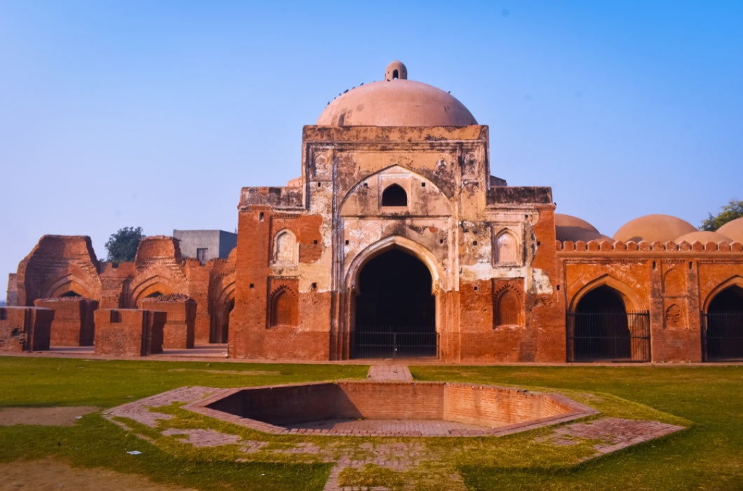 Landscape-photos-of-Kabuli-bagh-masjid-front-side-with-one-side-damaged-Tomb-and-wall-blue-sky-and-green-grass-Panipat-India.jpg